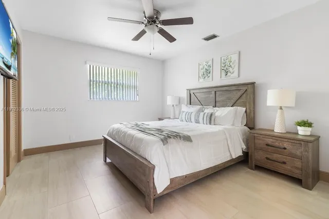 a bedroom with a bed dresser and a window