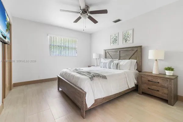 a bedroom with a bed dresser and a window