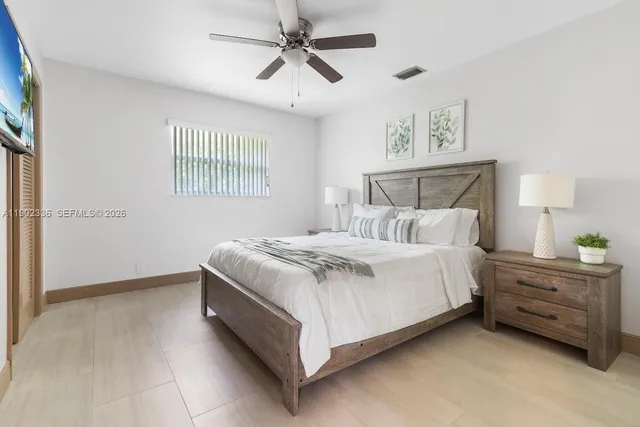 a bedroom with a bed dresser and a window