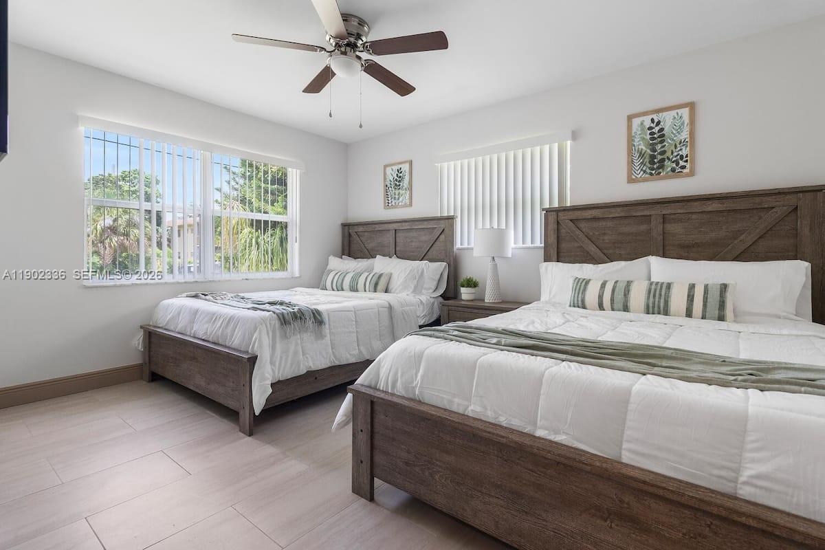 1500 Northwest 45th Street Pompano Beach, FL 33064 - Photo 16 of 23 a bedroom with two beds and a large window