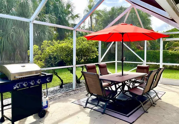 a view of deck with furniture and barbeque oven