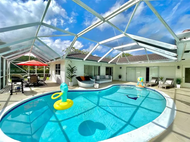 a view of a swimming pool with chairs and tables