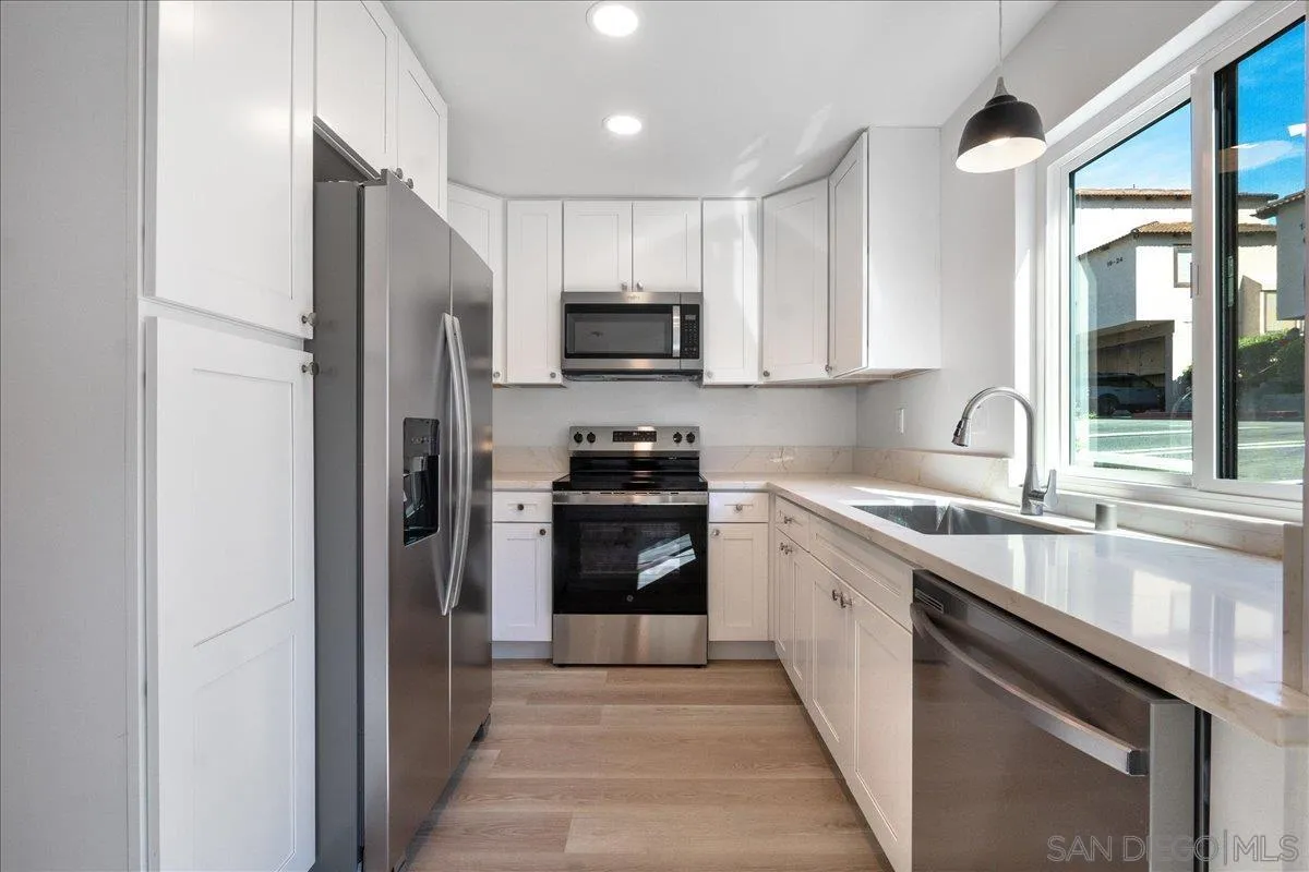 a kitchen with a sink stove and refrigerator