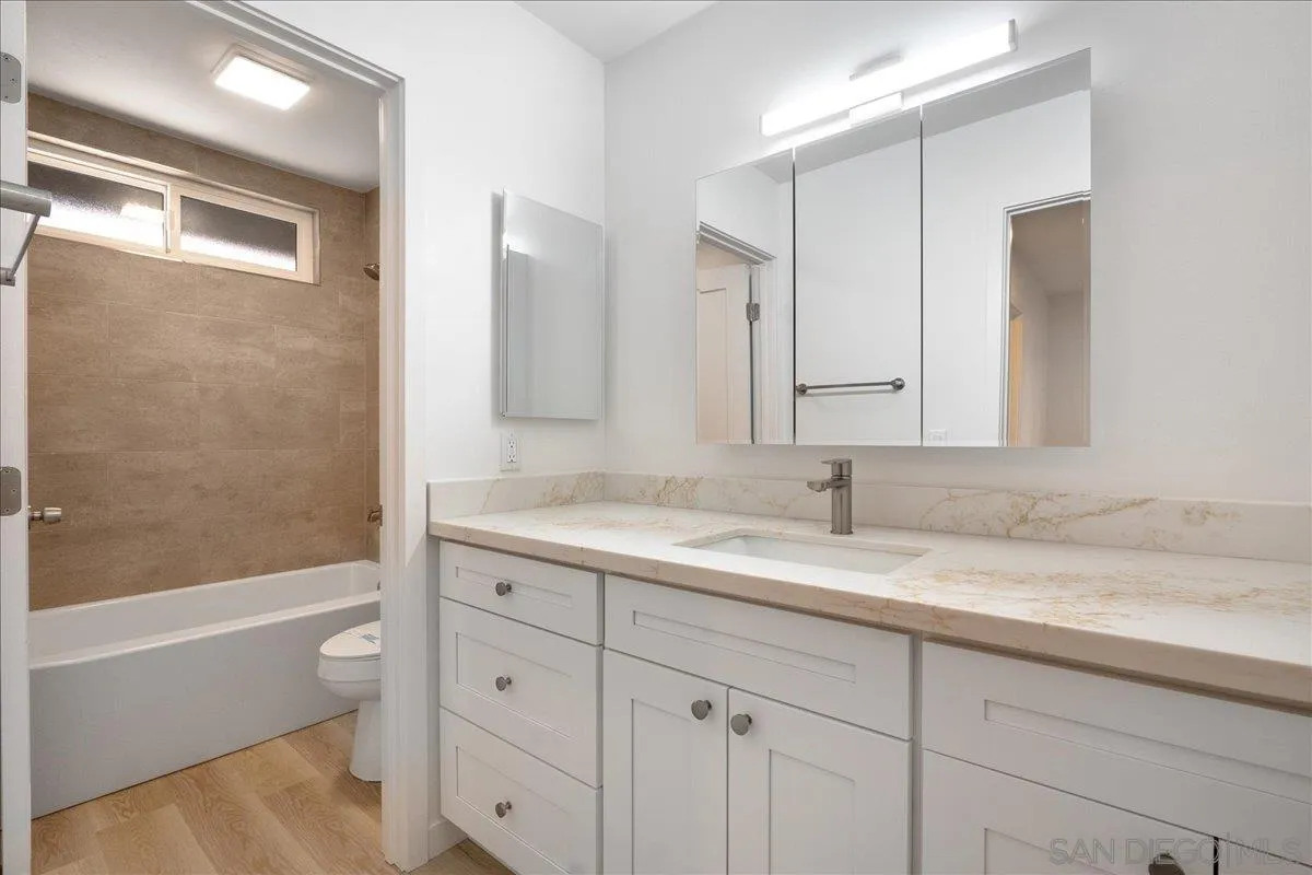 955 Postal Way, Unit 29 Vista, CA 92083 - Photo 14 of 32 a bathroom with a granite countertop sink a toilet and bathtub