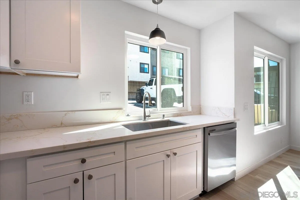 955 Postal Way, Unit 29 Vista, CA 92083 - Photo 4 of 32 a kitchen with a sink and cabinets