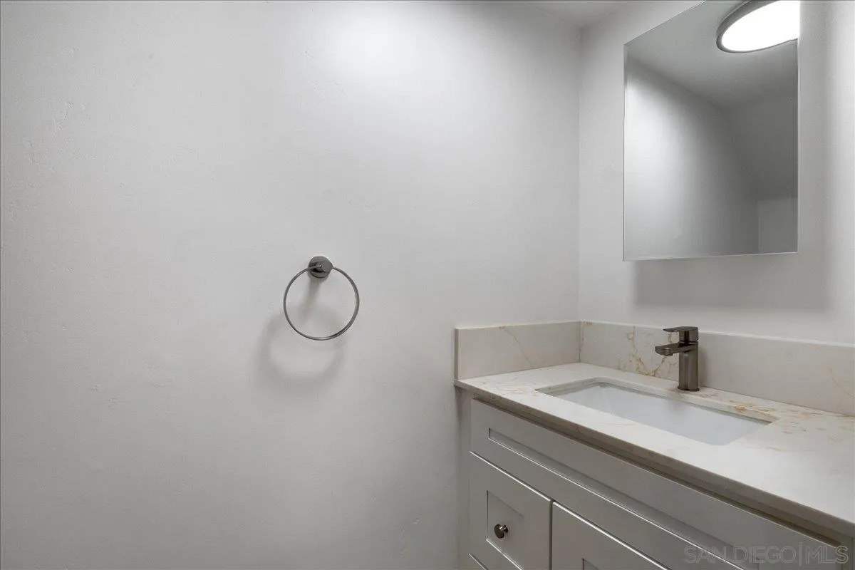 955 Postal Way, Unit 29 Vista, CA 92083 - Photo 9 of 32 a bathroom with a sink and vanity