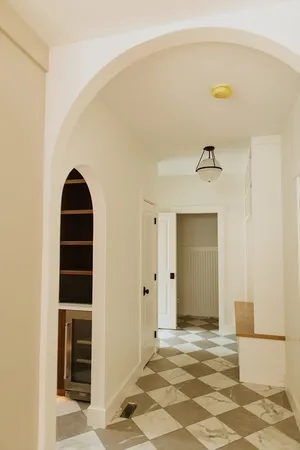 a view of a hallway with wooden floor and staircase