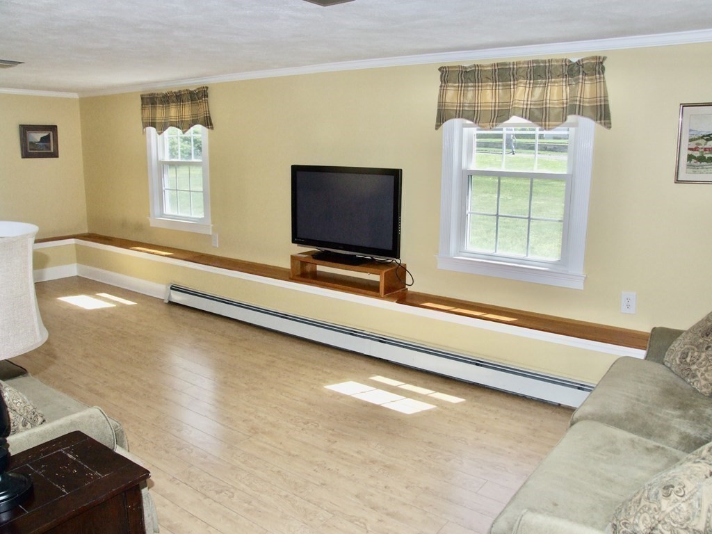 30 Donnell Road Walpole, MA 02032 - Photo 16 of 32 a living room with a bed furniture and a flat screen tv