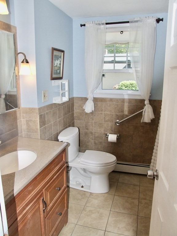 30 Donnell Road Walpole, MA 02032 - Photo 20 of 32 a bathroom with a granite countertop toilet sink and mirror