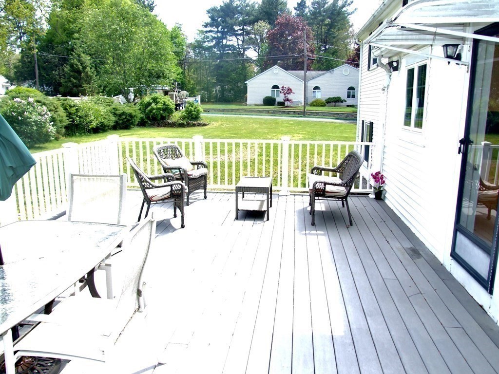 30 Donnell Road Walpole, MA 02032 - Photo 28 of 32 a view of deck with table and chairs wooden floor and fence