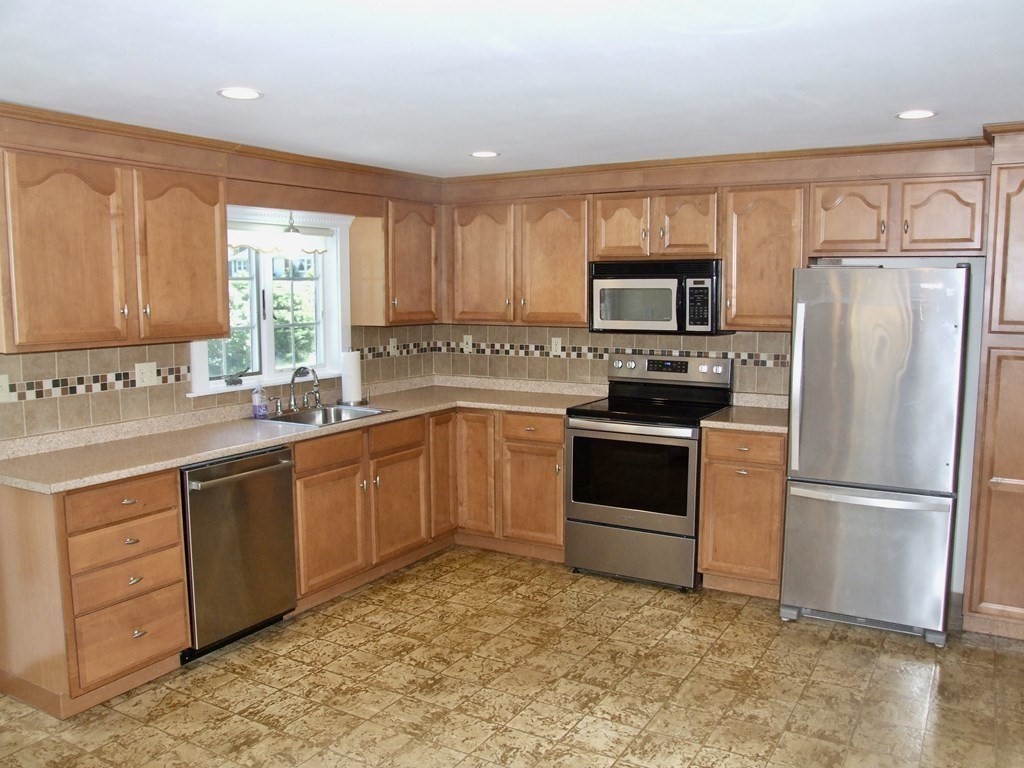 30 Donnell Road Walpole, MA 02032 - Photo 7 of 32 a kitchen with a refrigerator stove top oven and sink