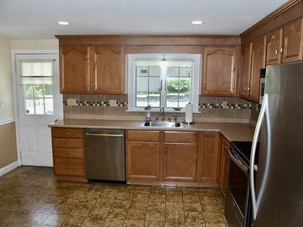 30 Donnell Road Walpole, MA 02032 - Photo 8 of 32 a kitchen with stainless steel appliances granite countertop a refrigerator sink and cabinets