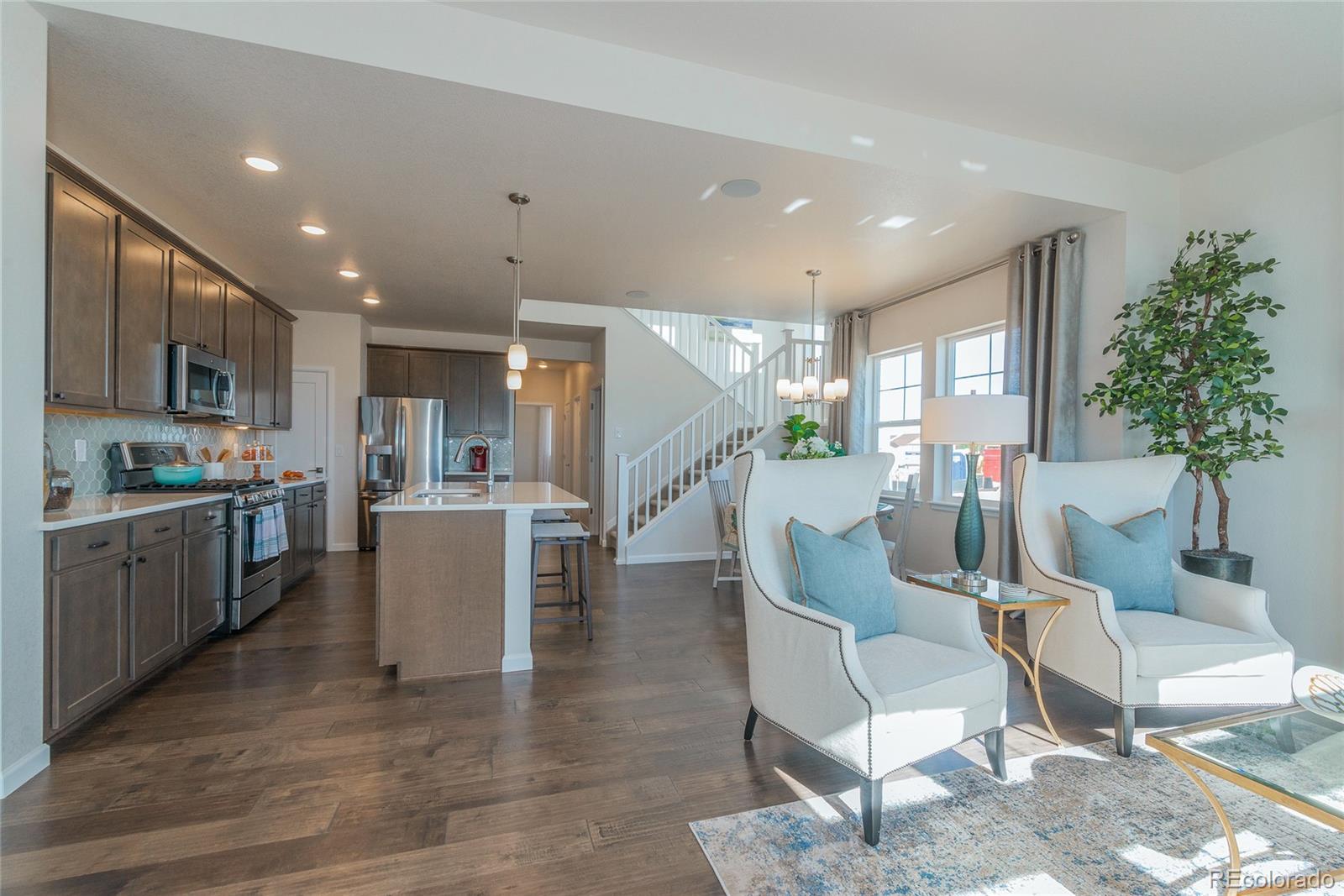 15501 East 112th Avenue, Unit 1D Commerce City, CO 80022 - Photo 1 of 31 a kitchen with furniture and a potted plant