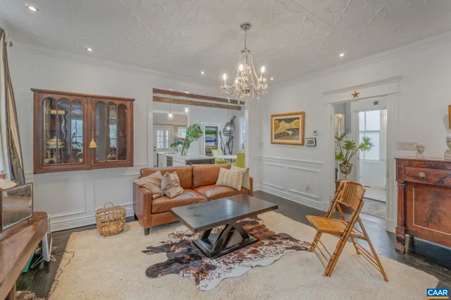 a living room with furniture and stairs