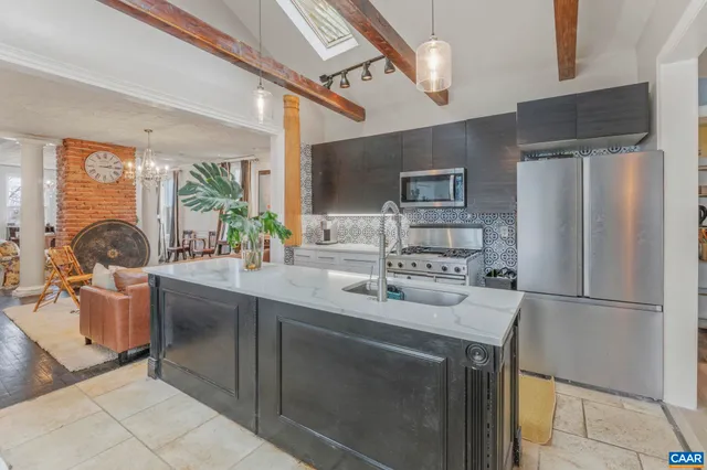 a view of staircase with lots of frames on wall and wooden floor