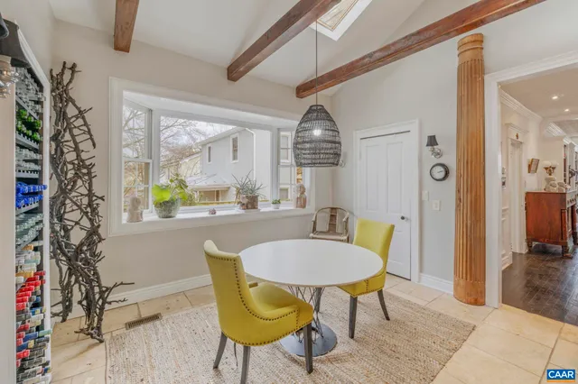 a bedroom with a bed a chandelier and a couch
