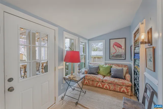 a spacious bedroom with a bed and a chandelier