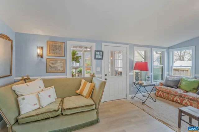 a spacious bedroom with a bed mirror and a window