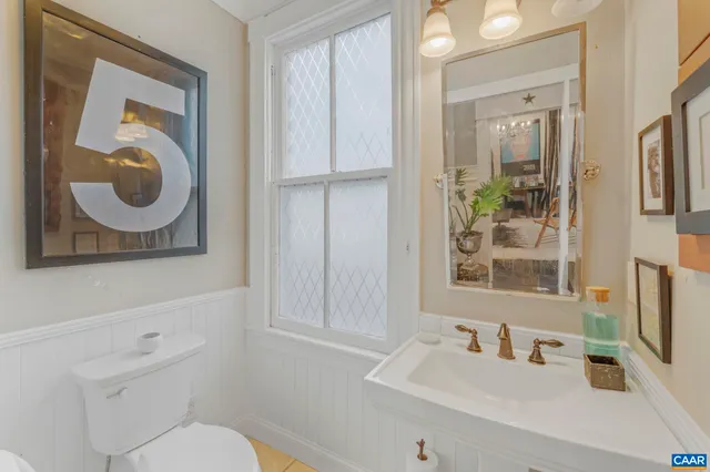 a view of staircase with railing and white walls