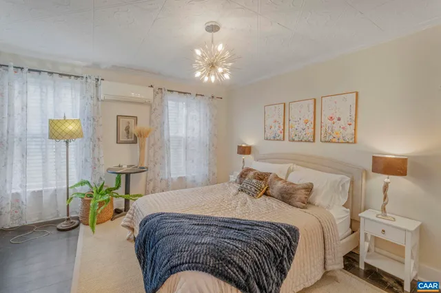 a bedroom with a bed and a chandelier