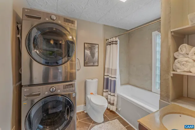 a white toilet sitting next to a bath tub shower