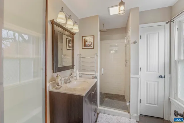 a view of a house with a flower garden in front of it