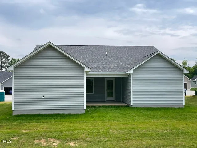 a view of a house with a backyard