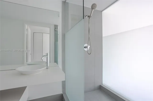 a bathroom with a glass shower door