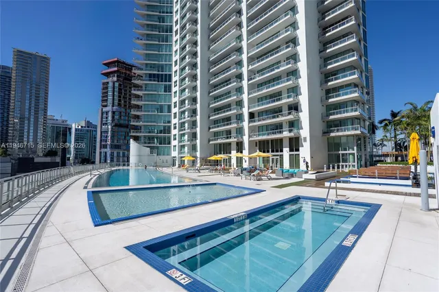 a view of a swimming pool with chairs
