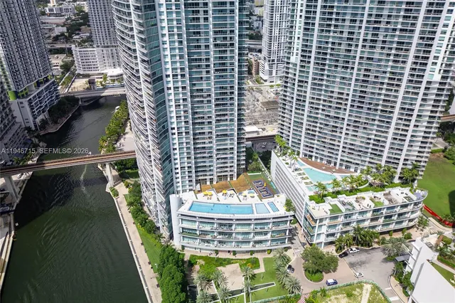 a view of a backyard with plants and outdoor seating