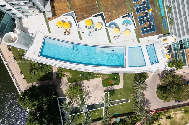 a kitchen with stainless steel appliances kitchen island granite countertop a stove and a sink