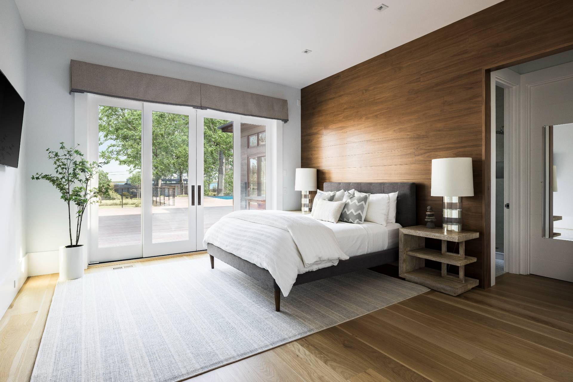 26 Mashomuck Drive Sag Harbor, NY 11963 - Photo 14 of 25 a spacious bedroom with a large bed and a large window