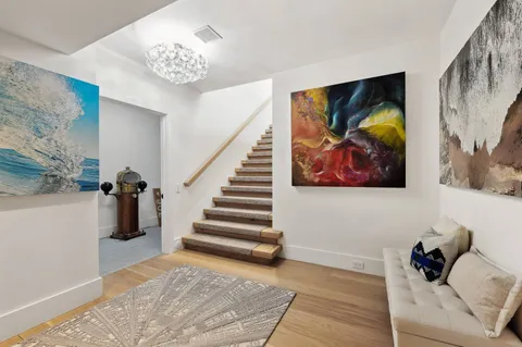 a bedroom with a bed and a painting on the wall