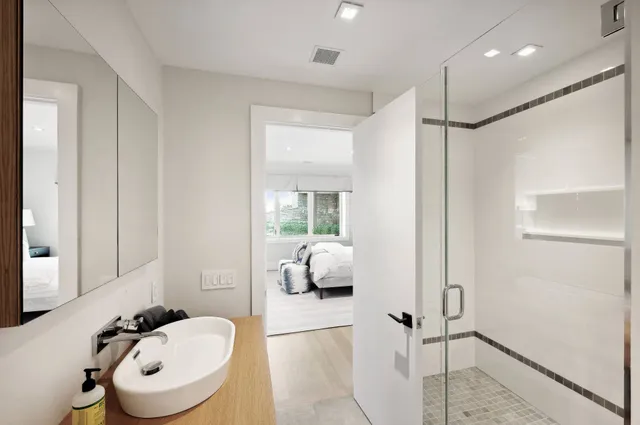 a bathroom with a sink a toilet and shower