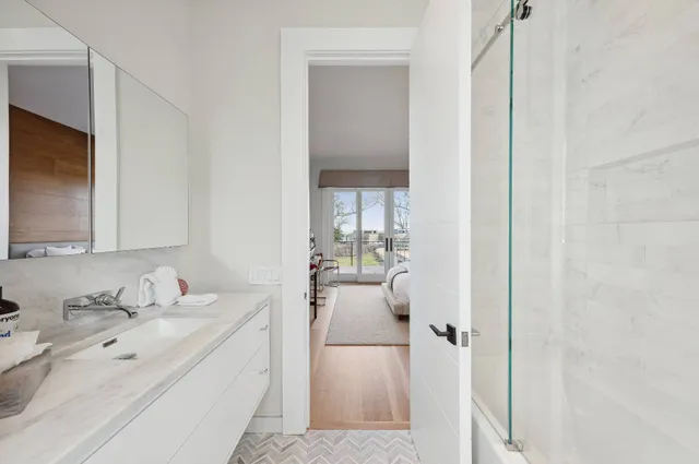 a en suite bathroom with a sink double vanity and mirror