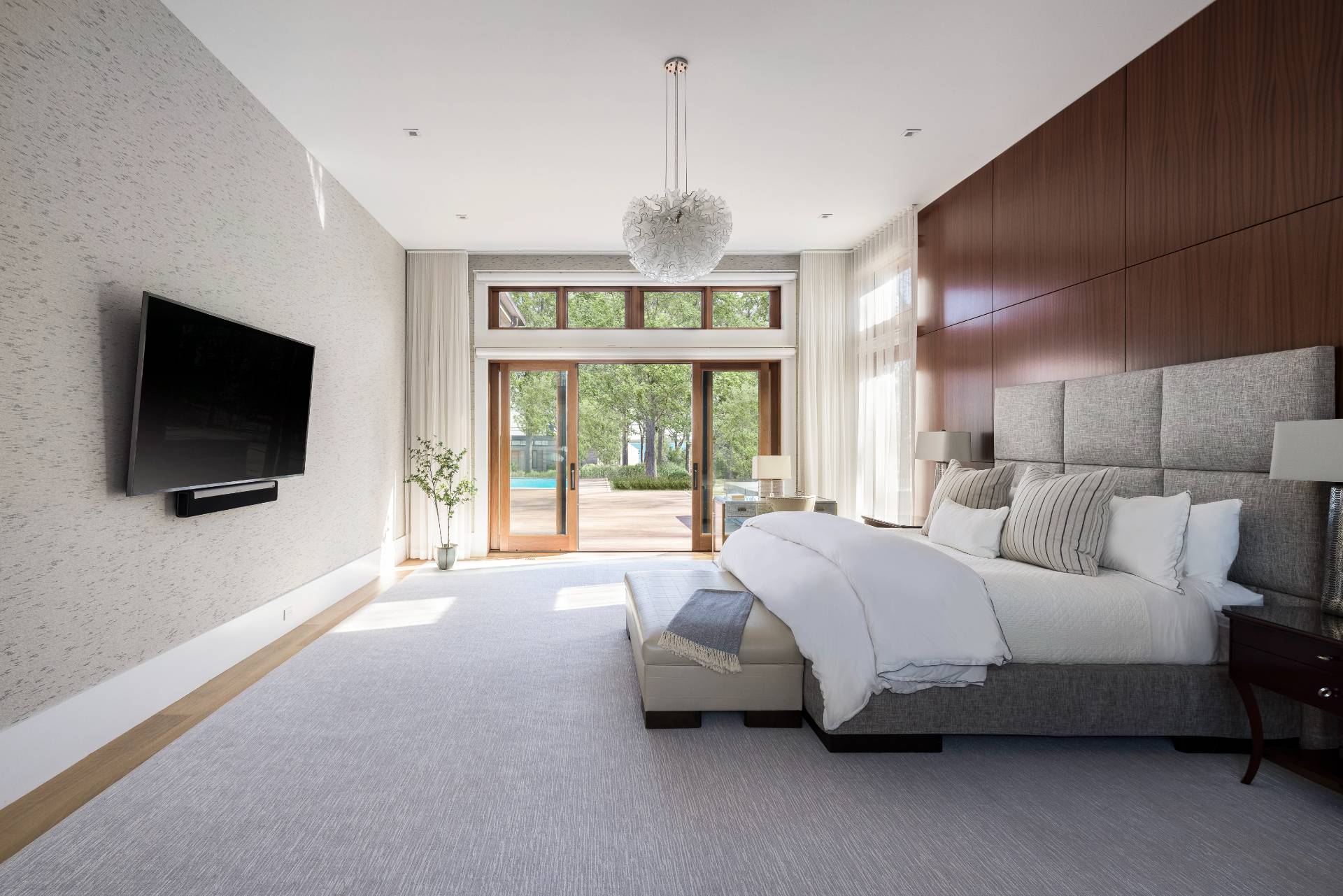 26 Mashomuck Drive Sag Harbor, NY 11963 - Photo 9 of 25 a spacious bedroom with a bed and a flat screen tv