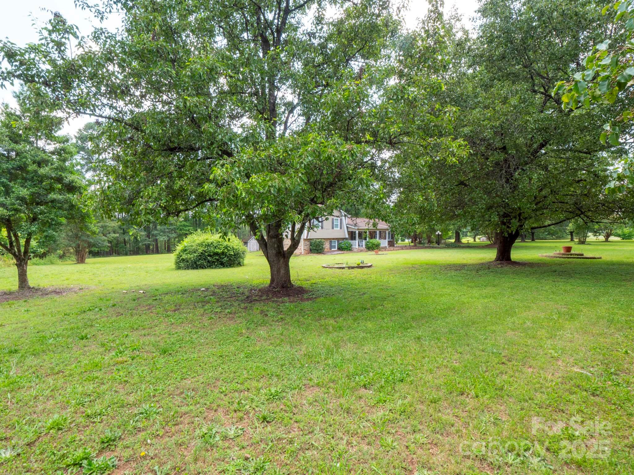 409 State Rd S-46-27 Clover, SC 29710 - Photo 8 of 43 a huge green field with lots of trees