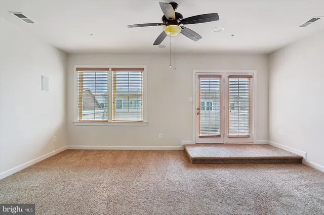 a view of livingroom with hardwood floor and a ceiling fan