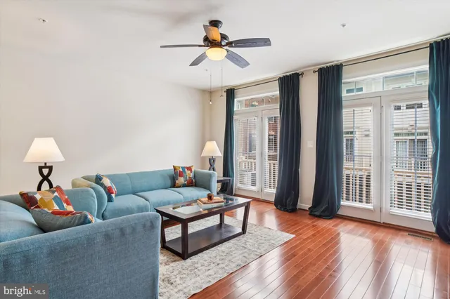 a living room with furniture and a chandelier