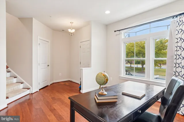 a view of a workspace with furniture and a window