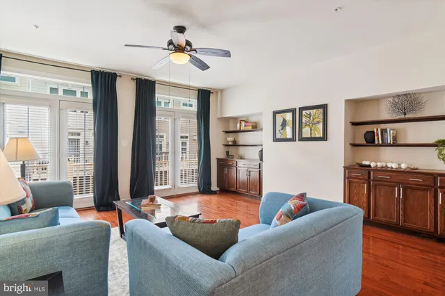 a living room with furniture and a kitchen