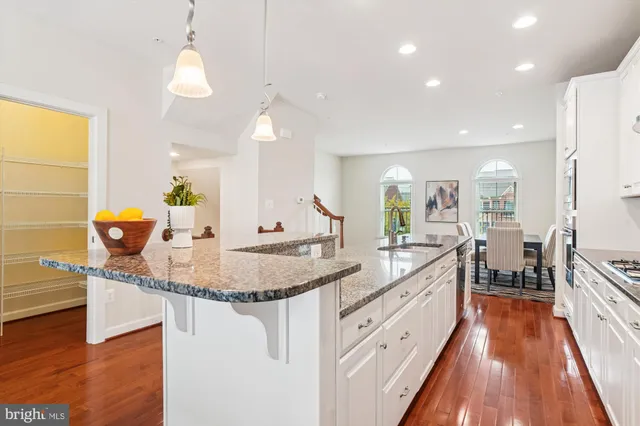 a kitchen with stainless steel appliances granite countertop a sink and a stove