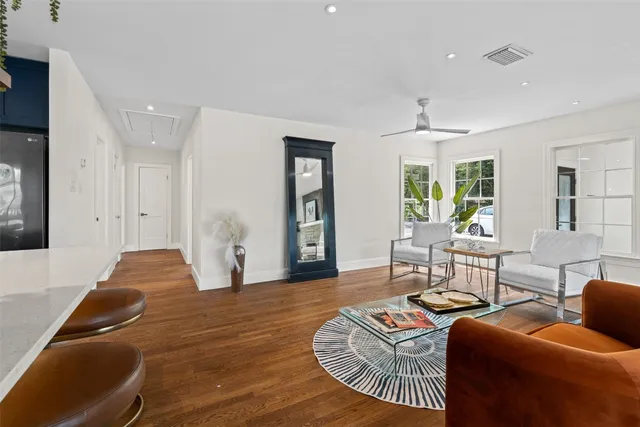 a living room with furniture and wooden floor
