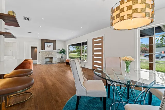 a living room with furniture a flat screen tv and a dining table