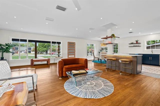 a living room with furniture and a wooden floor