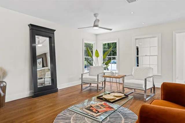 a living room with furniture and wooden floor