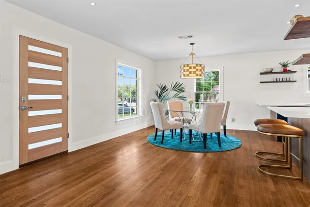 a dining room with furniture a window and wooden floor