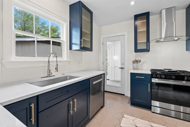 a kitchen with cabinets and window