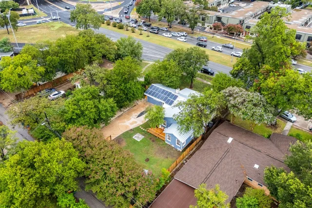 an aerial view of a residential houses with outdoor space