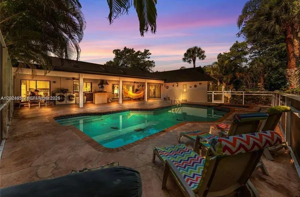 swimming pool view with a seating space